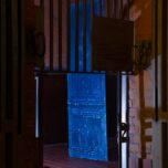 Constantin&#039;s work „trap” photographed through the still intact bars of the former bear cage. The work consists of a bright blue resin mold of a richly ornamented door.